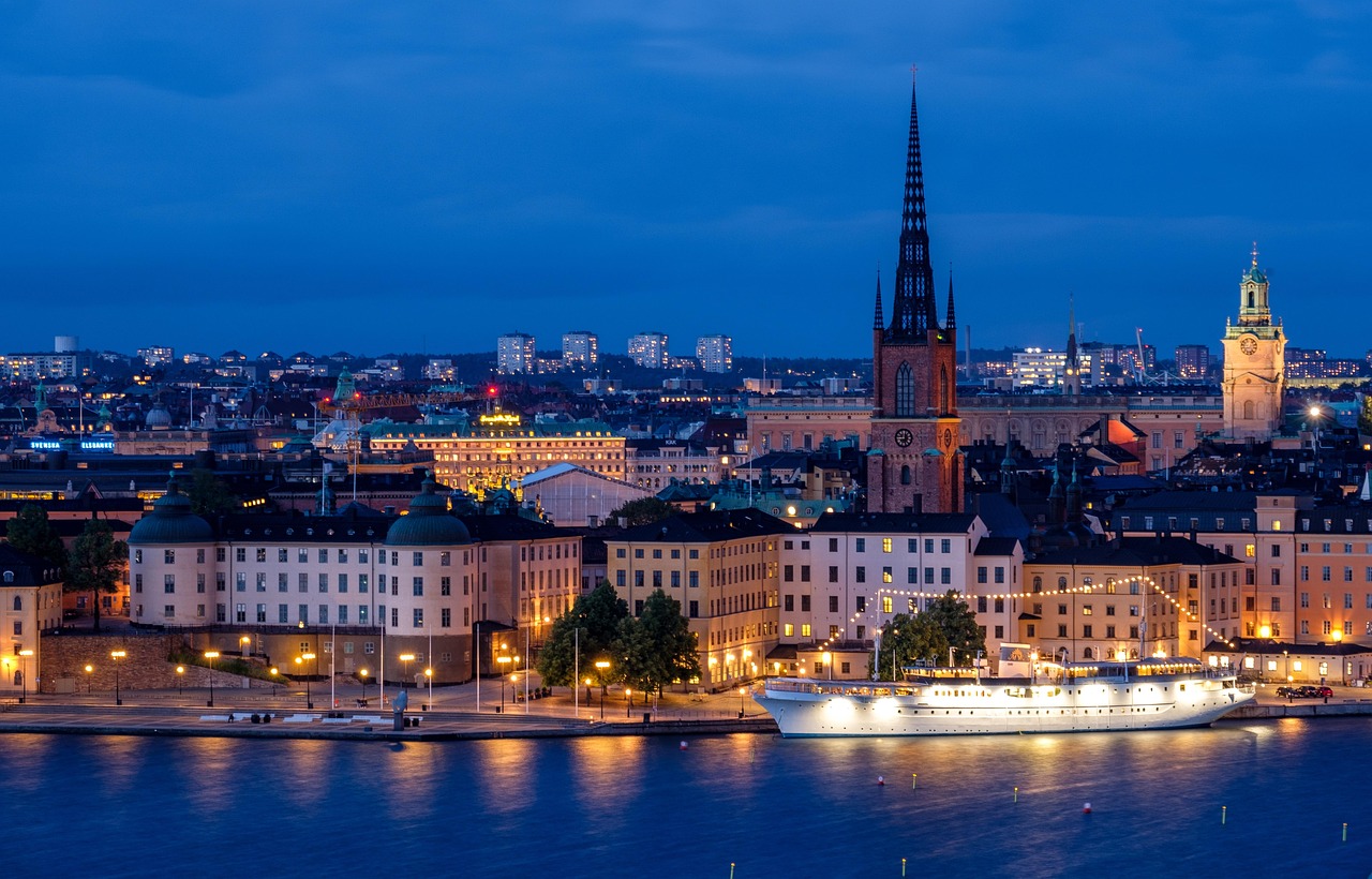 city, cityscape, nature, waterfront, illuminated, ship, architecture, skyline, historic center, church, steeple, water, sea, night, evening, twilight, lights, mirroring, stockholm, sweden, scandinavia